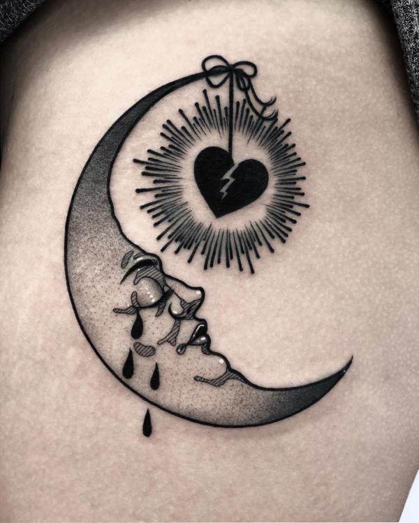 Broken heart with halo and crescent moon with tears tattoo