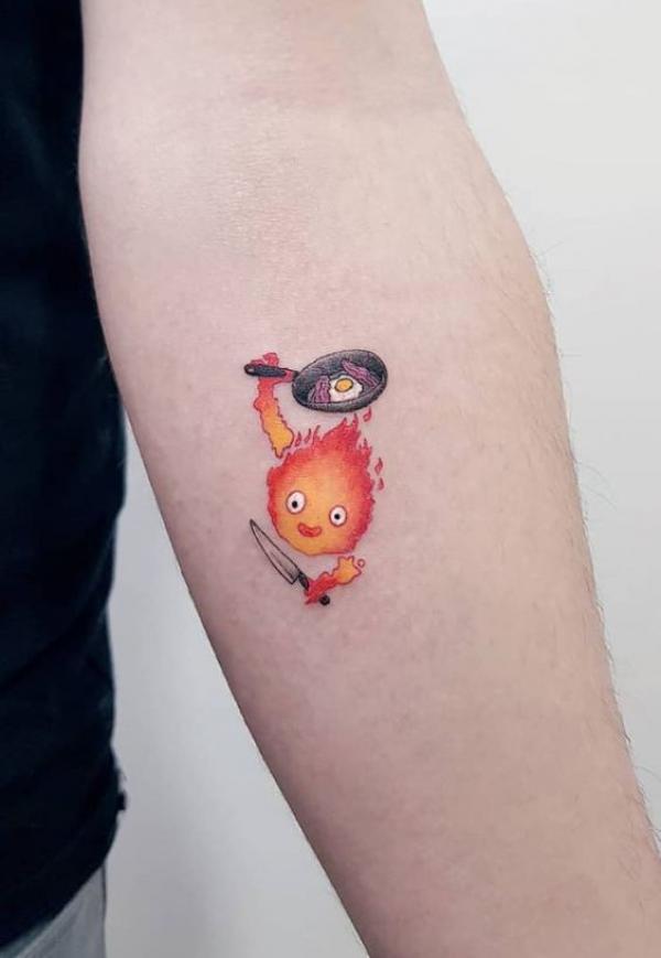 Calcifer holding a pan frying egg tattoo