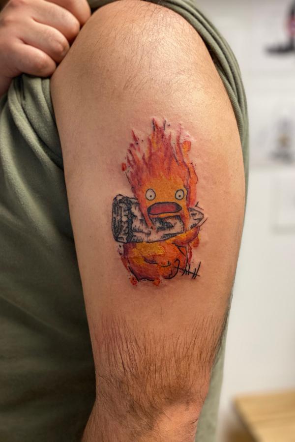 Calcifer upper arm tattoo