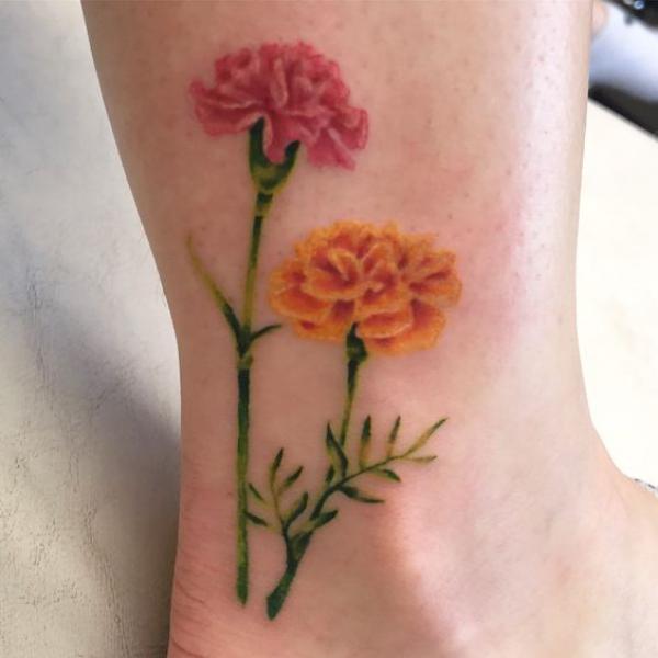Carnation and marigold tattoo