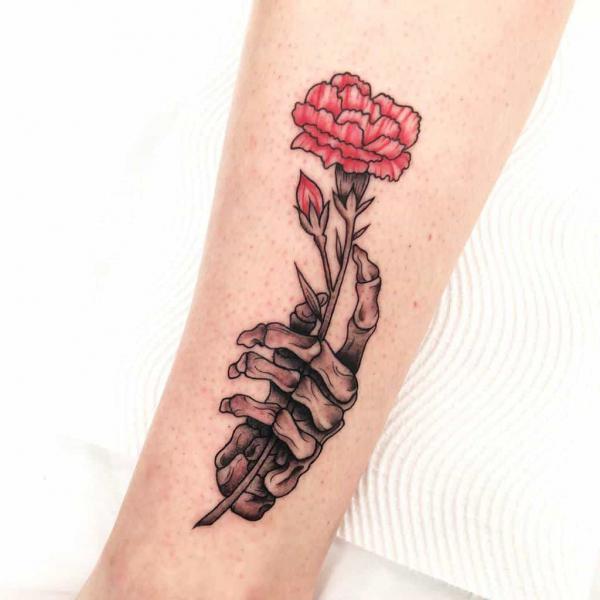 Carnation and skeleton hand tattoo