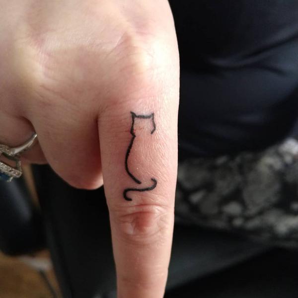Cat outline finger tattoo