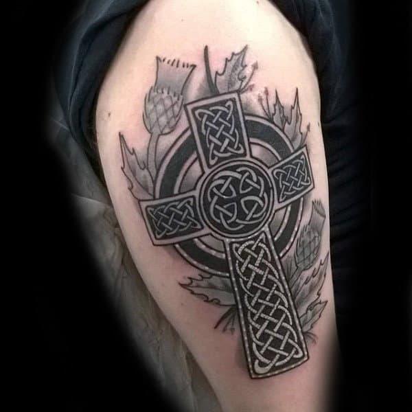 Celtic cross with thistle upper arm tattoo 1