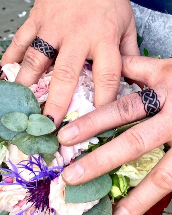 Celtic knot ring finger tattoo