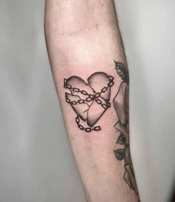 Chain wrapped broken heart tattoo