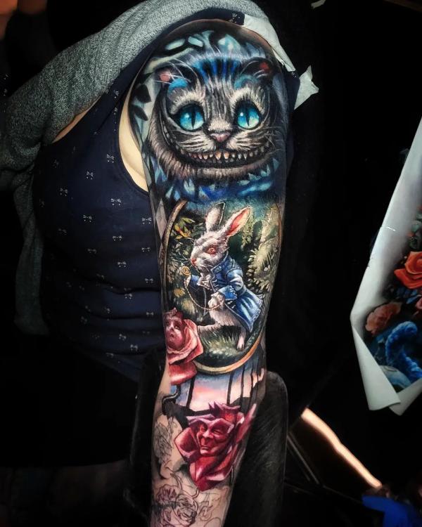 Cheshire Cat and white rabbit with roses sleeve tattoo