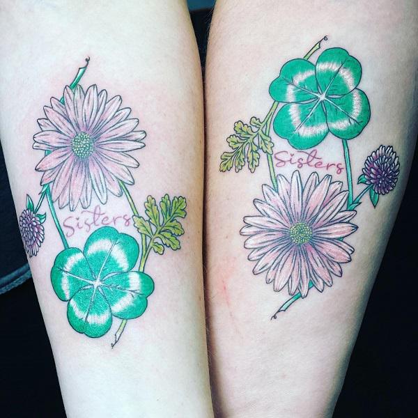 Clover and daisy matching tattoos for sisters