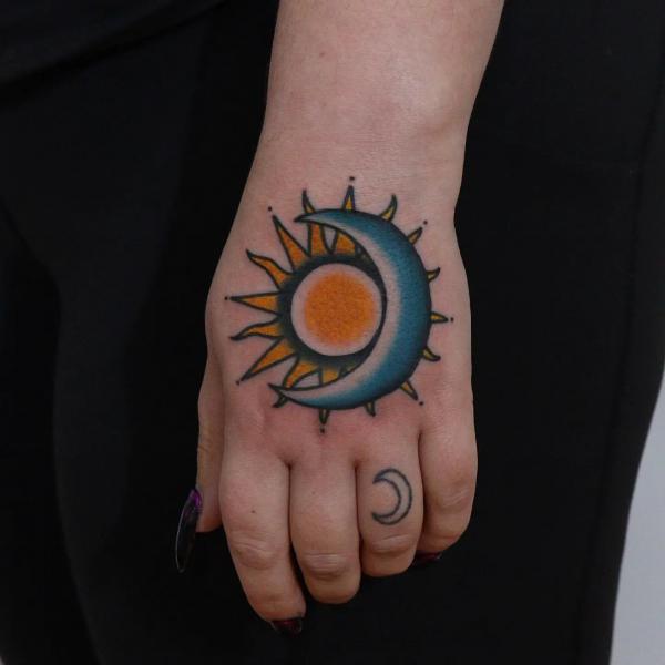 Colored Sun and moon hand tattoo