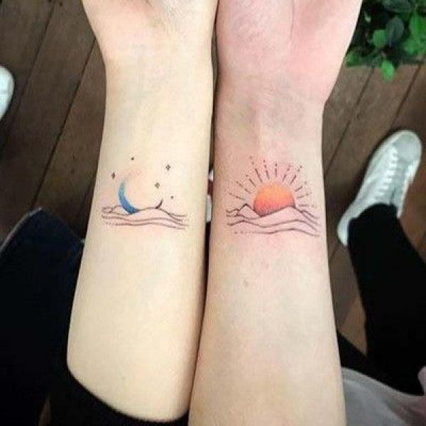 Colored sun and moon and ocean tattoo