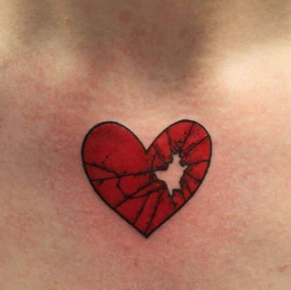 Cracked red heart chest tattoo