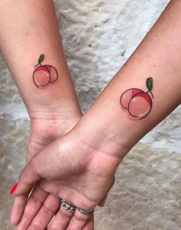 Cute Peach matching tattoo for sisters