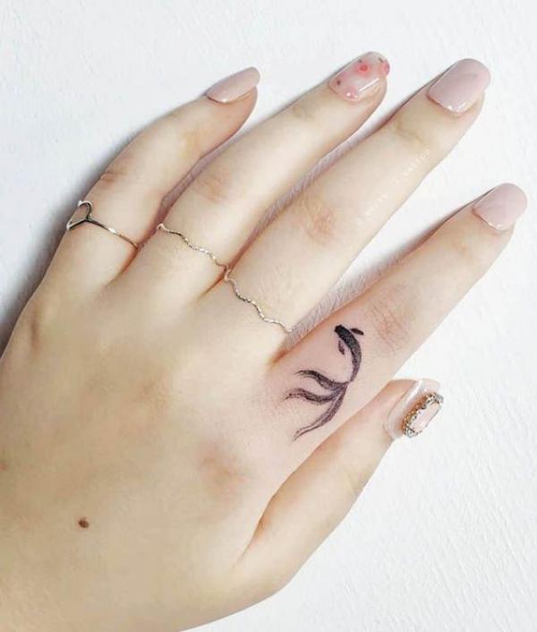Cute gold fish tattoo on index finger