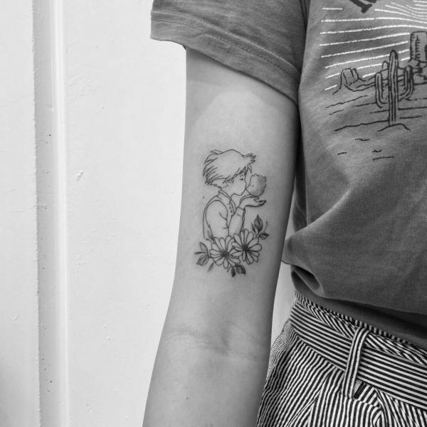 Dainty Sophie catching calcifer bicep tattoo