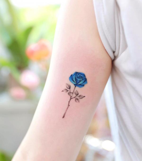Dainty blue rose tattoo