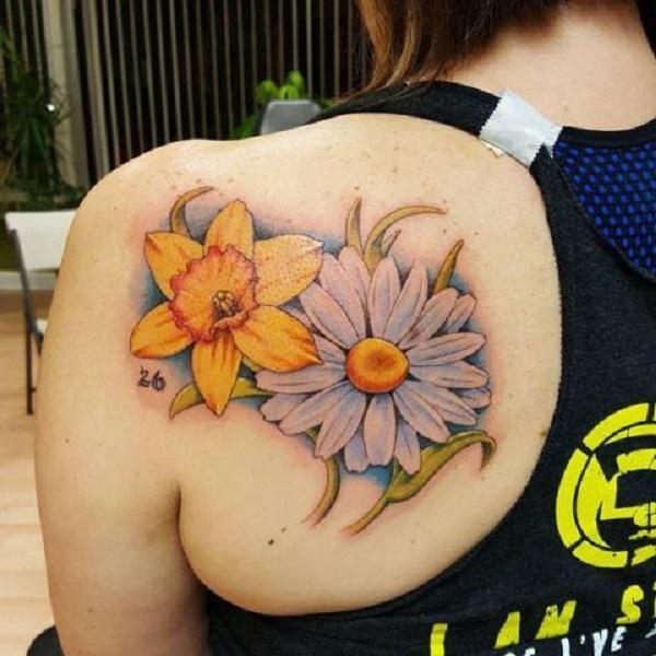 Daisy and daffodil shoulder blade tattoo