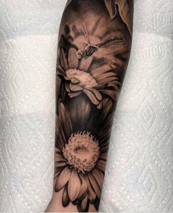 Daisy and dragonfly sleeve tattoo