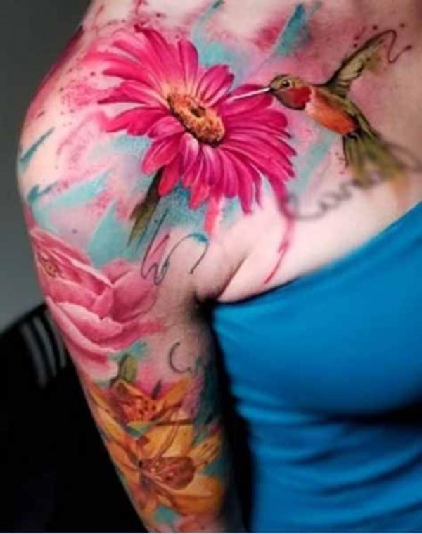 Daisy and hummingbird shoulder tattoo