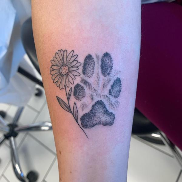 Daisy and paw print tattoo