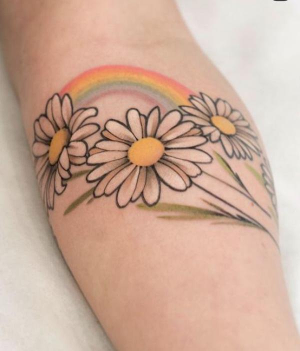 Daisy and rainbow tattoo