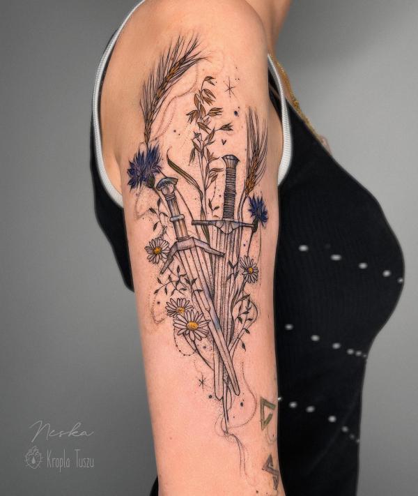 Daisy and sword tattoo