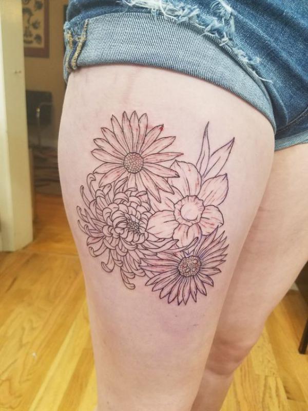 Daisy chrysanthemum and daffodil thigh tattoo