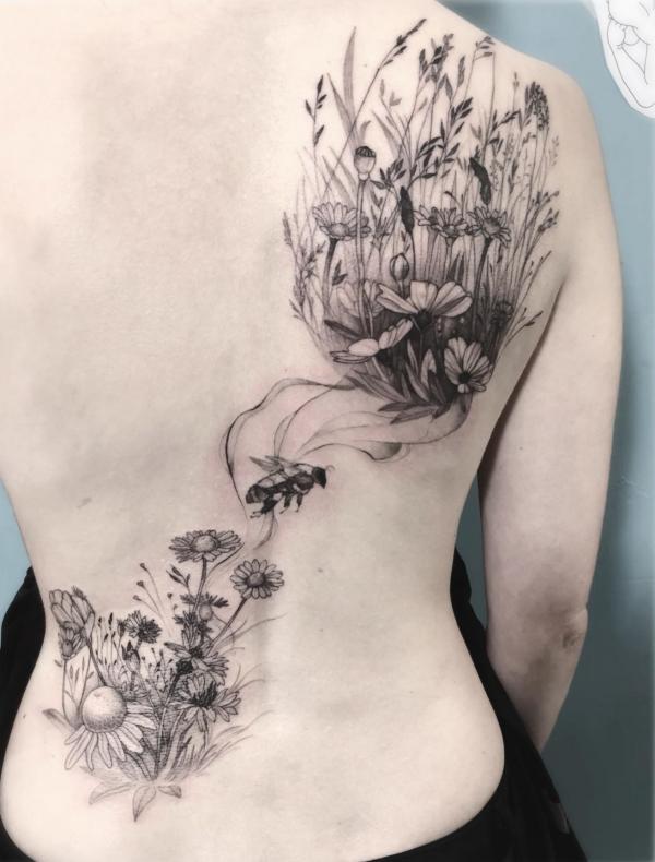 Daisy drawing back tattoo
