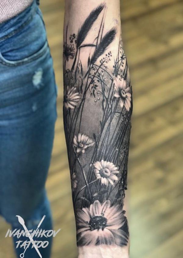 Daisy forearm tattoo