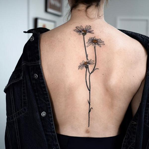 Daisy spine tattoo