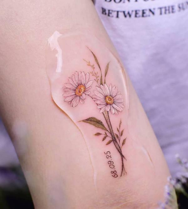 Daisy with date tattoo