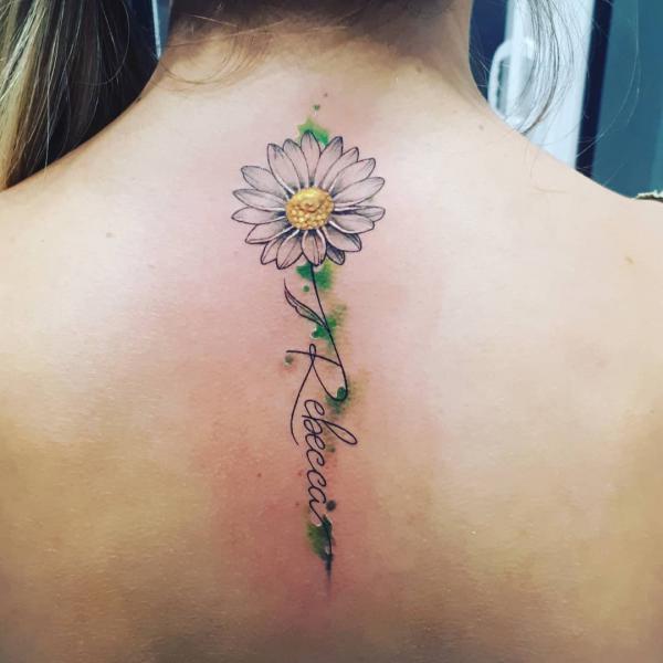 Daisy with name spine tattoo