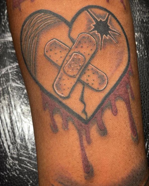 Dark broken heart with bandaid tattoo