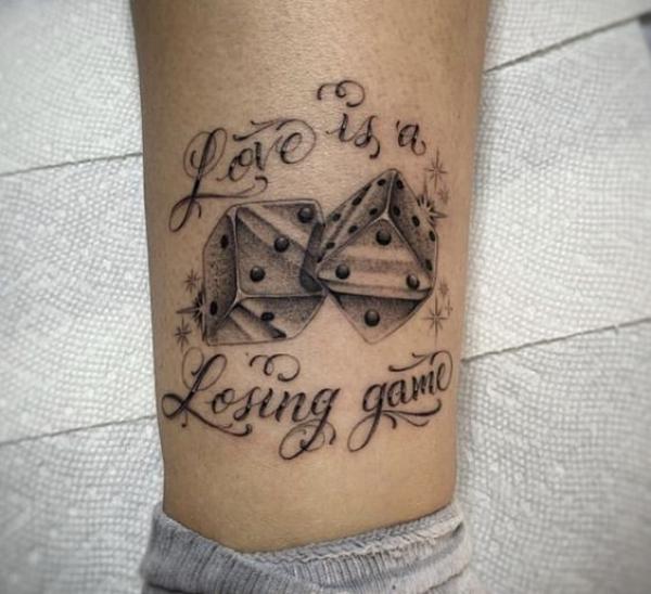 Dices tattoo with quote Love is a losing game
