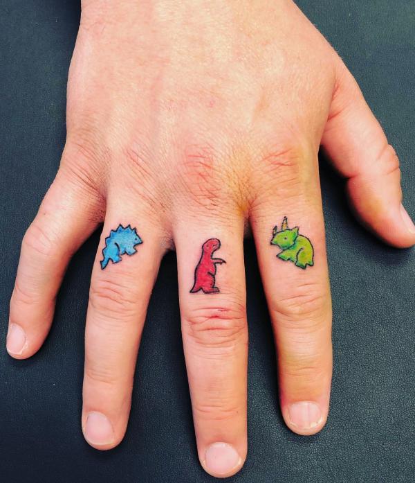 Dinosaur finger tattoo