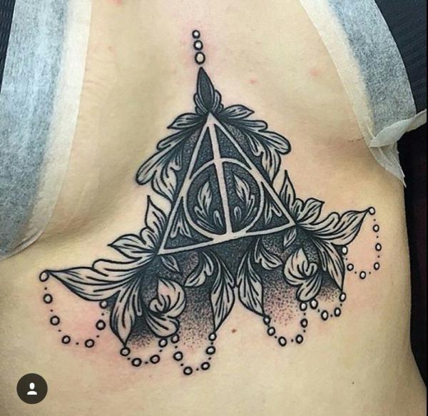 Dotwork deathly hallows with leaves sternum tattoo
