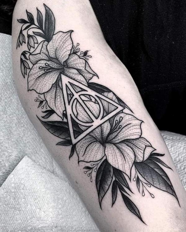Dotwork deathly hallows with lilies tattoo