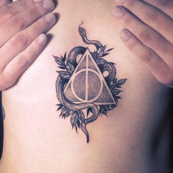 Dotwork deathly hallows with snake sternum tattoo