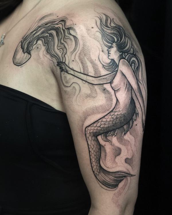 Dotwork mermaid and jellyfish upper arm tattoo