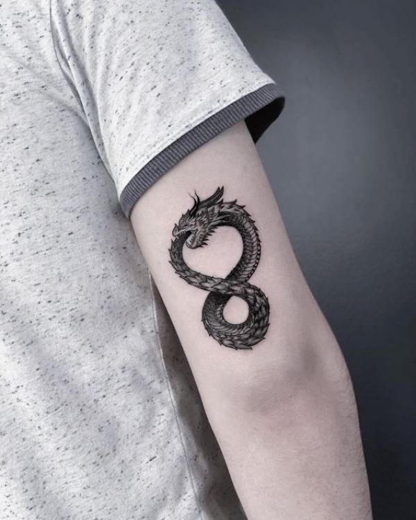 Dragon infinity tattoo on back of upper arm
