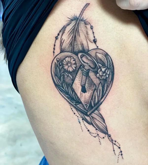 Feather and floral heart side boob tattoo