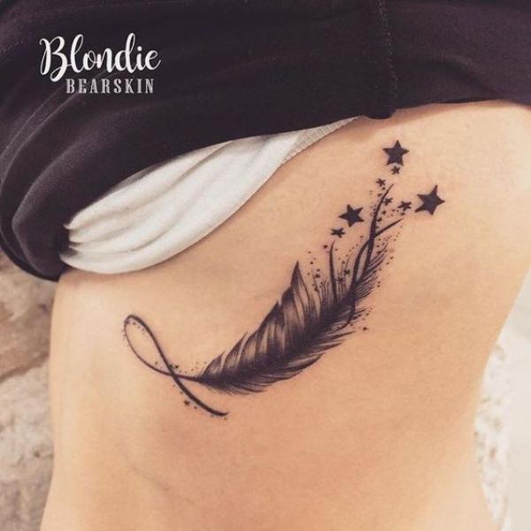 Feather and stars side boob tattoo