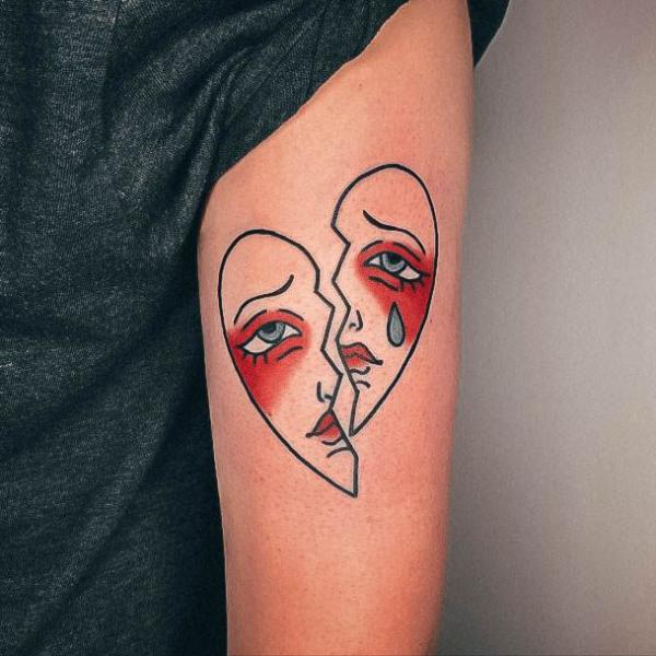 Female face broken heart tattoo