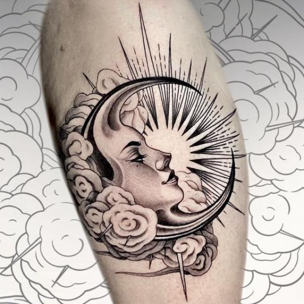 Female moon face and sun tattoo