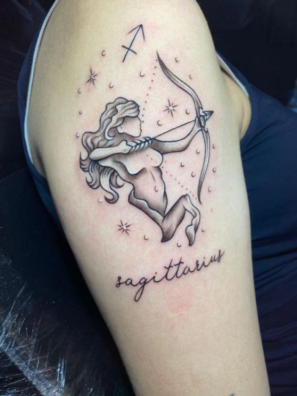 Feminine Sagittarius Archer with stars upper arm tattoo 1