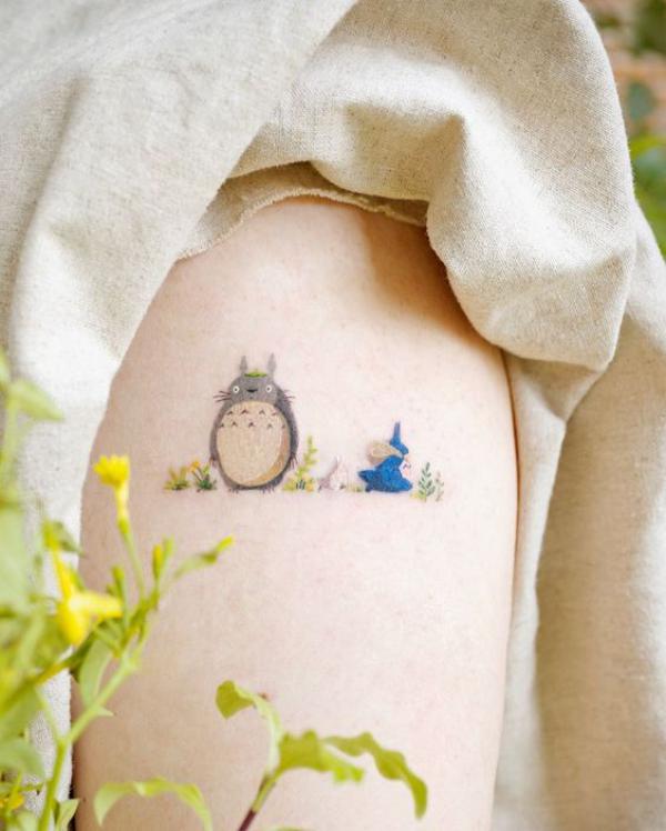Feminine Totoro arm tattoo