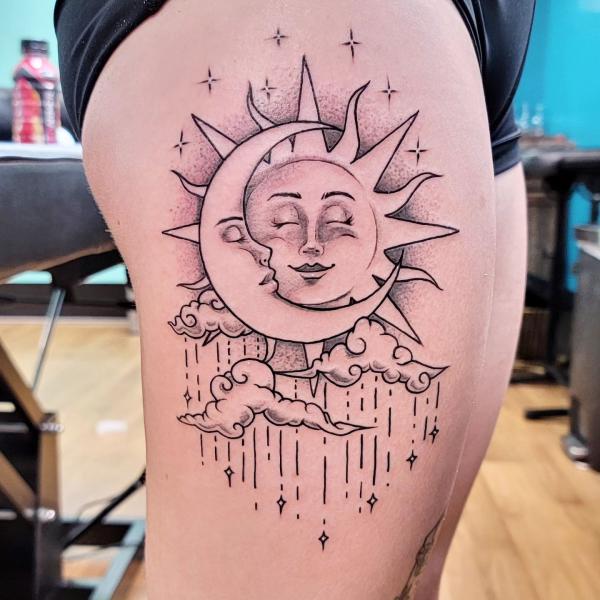 Feminine sun and moon thigh tattoo