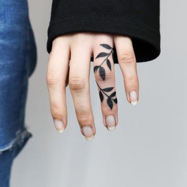 Fern leaves ring finger tattoo
