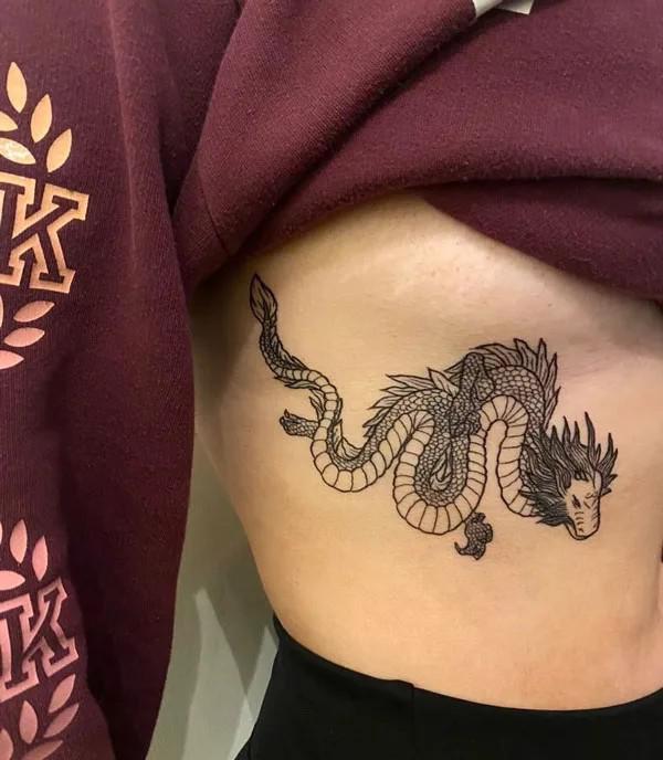 Fine line dragon side boob tattoo