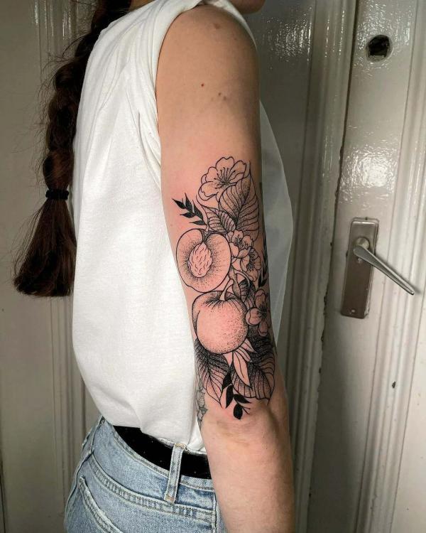 Fine line peach with flower upper arm tattoo