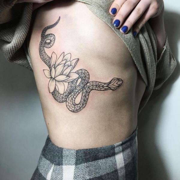 Fine line snake and water lily side boob tattoo