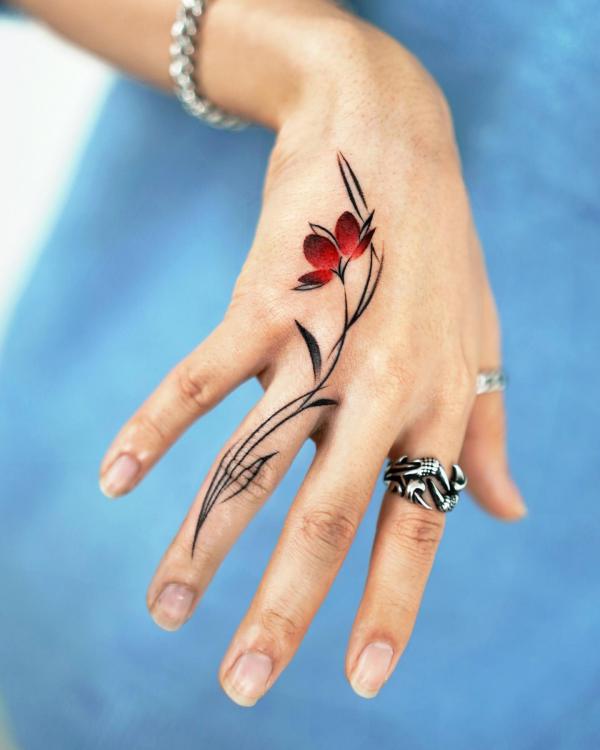 Floral vine finger tattoo